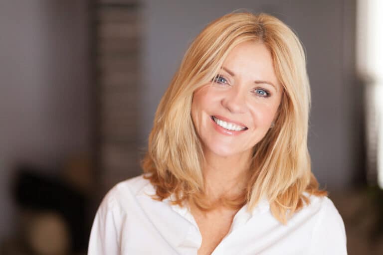 Middle,Aged,Woman,Smiling,At,The,Camera,At,Home.,White