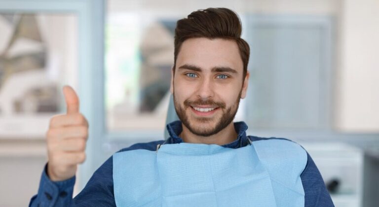 Cheerful,Bearded,Man,Patient,Sitting,In,Dental,Chair,And,Smiling
