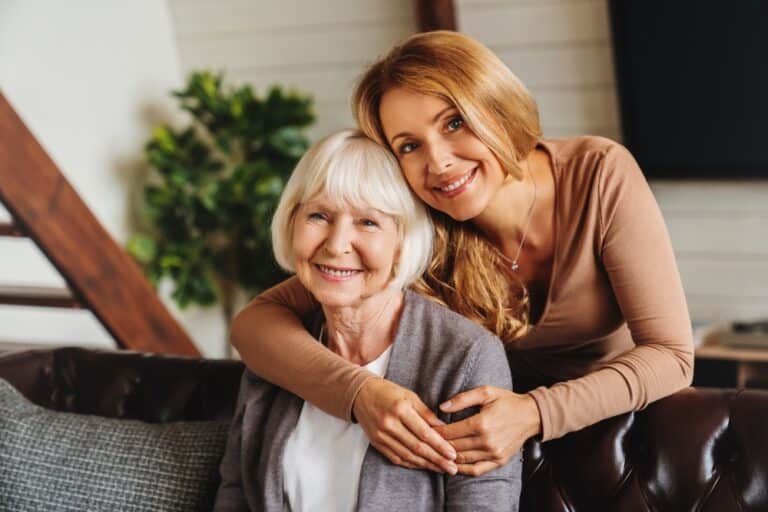 Cheerful,Middle,Aged,Woman,Embracing,Senior,Mother,At,Home,And