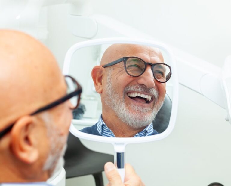 Happy,Senior,Patient,Admiring,His,Perfect,Smile,After,A,Dental